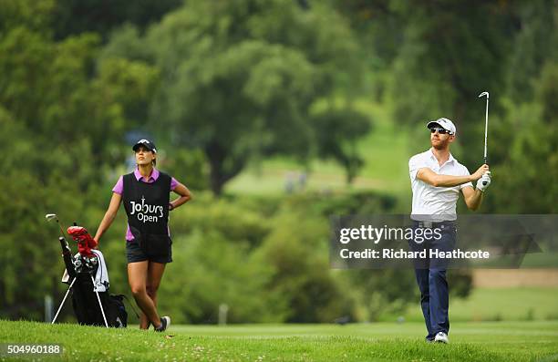 Estanislao Goya of Argentina is watched by caddie and Ladies European Tour player Henrietta Zuel on the East Course during day one of the Joburg Open...