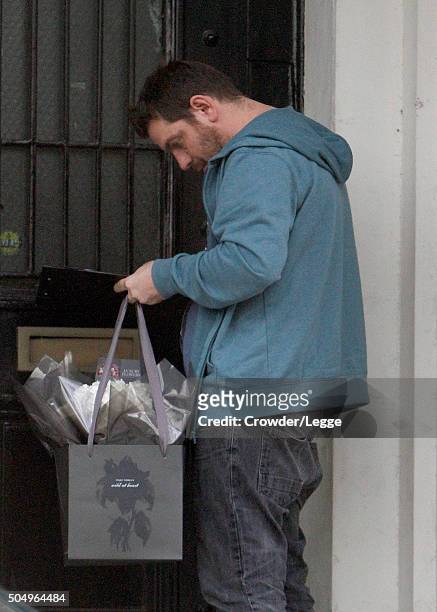 Man delivers flowers at the home of Alan and Rima Rickman on January 14, 2016 in London, England.