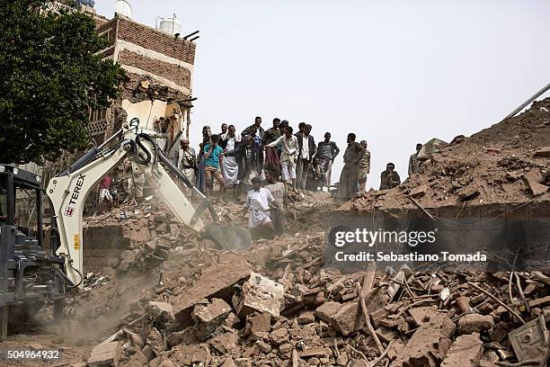 In the historical old city of Sana'a civilians, local response teams and Houthi fighters clear the rubble of four houses that were destroyed by a...