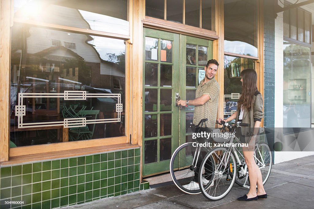 Australian mid adult couple locking their coffee shop business