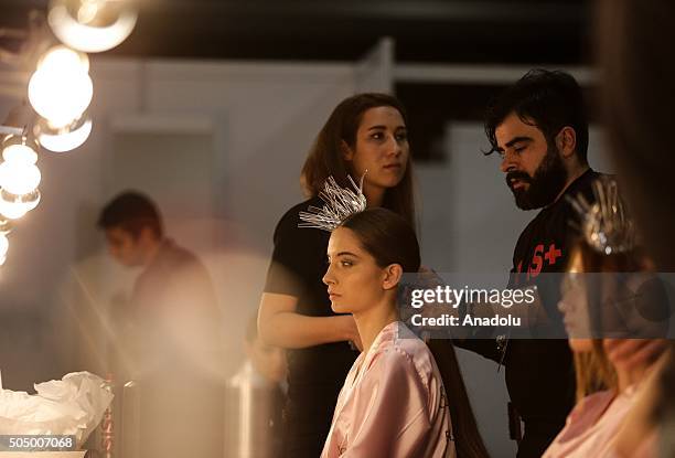 Model gets ready backstage during the "Profundo Del Mar" fashion show within the Fashionist Dress, Wedding Dress and Suit Fair in Istanbul, Turkey on...
