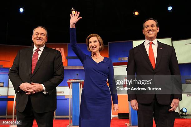 Republican presidential candidates Mike Huckabee, Carly Fiorina and Rick Santorum arrive on stage at the Fox Business Network Republican presidential...