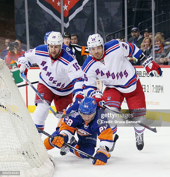 Tanner Glass and Viktor Stalberg of the New York Rangers go against Marek Zidlicky of the New York Islanders during the first period at the Barclays...