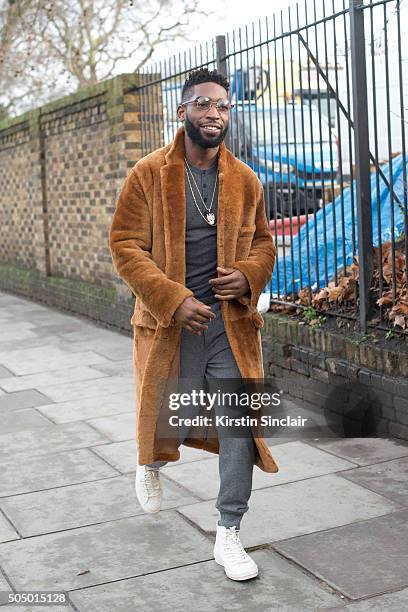 English rapper Tinie Tempeh wears Burberry coat and trousers on day 4 of London Collections: Men on Januay 11, 2016 in London, England. Tinie Tempeh