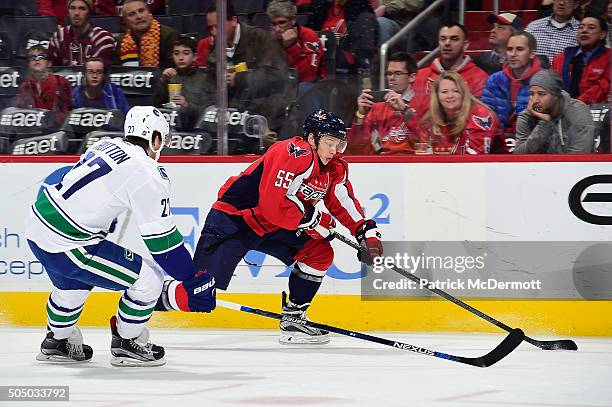 Aaron Ness of the Washington Capitals moves the puck up ice agaisnt Ben Hutton of the Vancouver Canucks in the first period during an NHL game at...