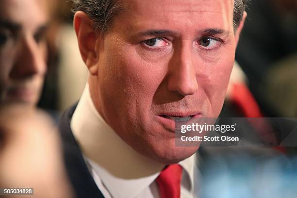 Republican presidential candidate Rick Santorum speaks to reporters in the spin room after the first part of the Fox Business Network Republican...