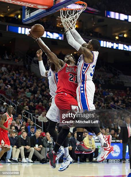 Nerlens Noel of the Philadelphia 76ers fouls Jimmy Butler of the Chicago Bulls on January 14, 2016 at the Wells Fargo Center in Philadelphia,...