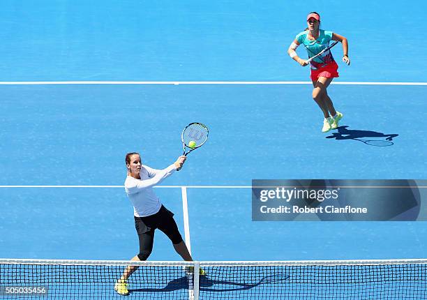 Jarmila Wolfe of Australia plays a backhand as Kimberly Birrell of Australia looks on in the women's doubles semi-final match againsts Anabel Medina...