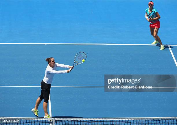 Jarmila Wolfe of Australia plays a backhand as Kimberly Birrell of Australia looks on in the women's doubles semi-final match againsts Anabel Medina...