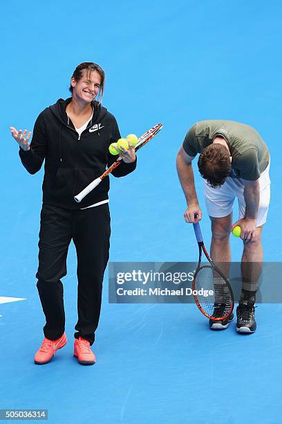 Andy Murray of Great Britain takes a moment to pause after his coach Amelie Mauresmo, who gestures, threw a ball and hit him during a practice...