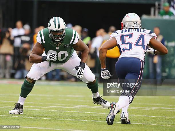 Brickashaw Ferguson of the New York Jets sets up against Dont'a Hightower of the New England Patriots during their game at MetLife Stadium on...