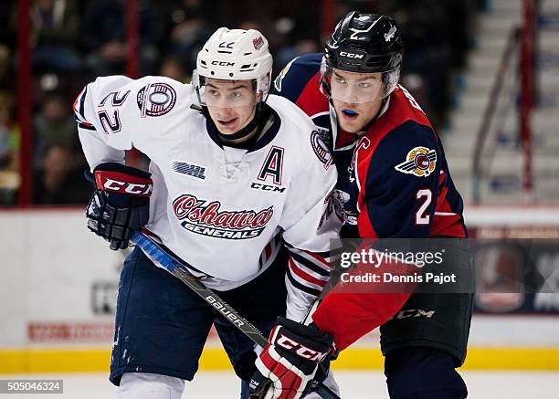 Forward Anthony Cirelli of the Oshawa Generals battles for the puck against defenceman Patrick Sanvido of the Windsor Spitfires on January 14, 2016...