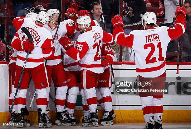 Danny DeKeyser of the Detroit Red Wings is congratulated by Joakim Andersson, Mike Green, Luke Glendening and Tomas Tatar after scoring the game...