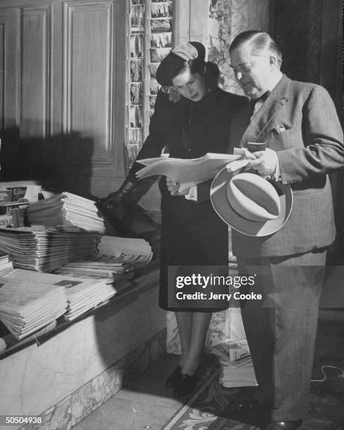 Mr. And Mrs. Axel Johsson at the Plaza Hotel news counter.