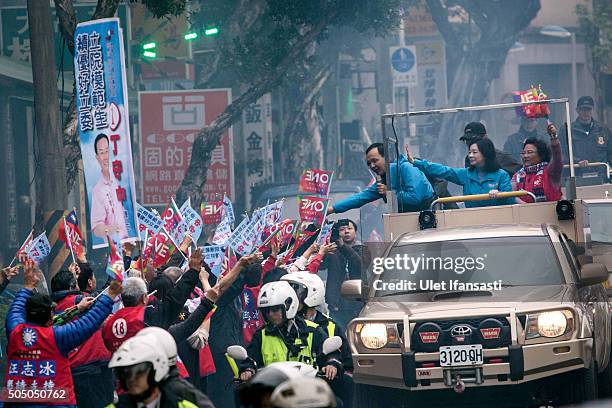 Kuomintang Party presidential candidate Eric Chu, waves to the supporters from a truck as he parades through the streets of Taiwan during rally...