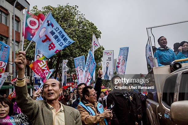 Kuomintang Party presidential candidate Eric Chu , waves to the supporters from a truck as he parades through the streets of Taiwan during rally...