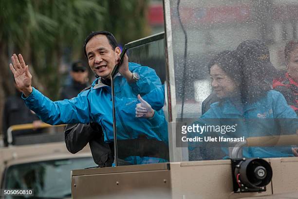 Kuomintang Party presidential candidate Eric Chu, waves to the supporters from a truck as he parades through the streets of Taiwan during rally...