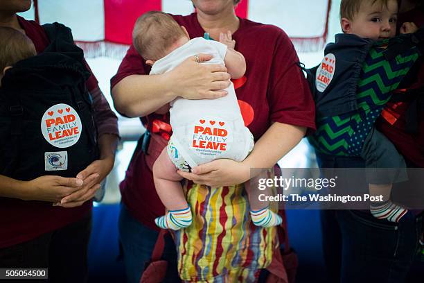 Tanya Snyder holding Milo Evans-Snyder, 5 months old, left, Jessica Champagne holding Benjamin Roth-Champagne, 3 moths old, center, and Jamie Davis...