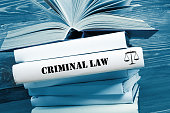 Book with Criminal Law word on table in a courtroom