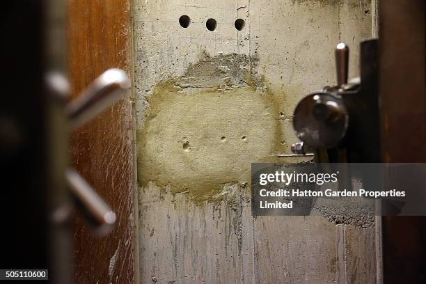 The reinforced steel door and the sealed hole that had been cut through the 50cm-thick concrete wall are pictured in the underground vault of the...