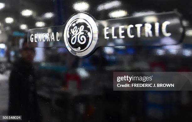 Man is reflected on the black door of a General Electric refrigerator at a store selling electronics and appliances in Montebello, California on...