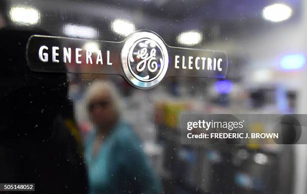 Woman is reflected on the black door of a General Electric refrigerator at a store selling electronics and appliances in Montebello, California on...