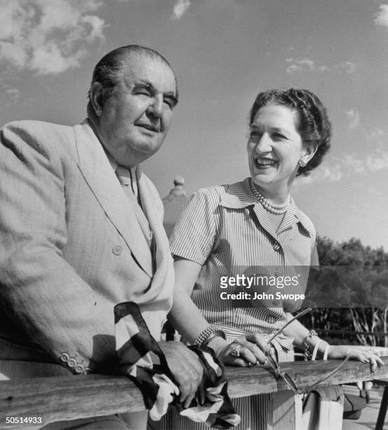 Gilbert Miller, theatrical producer, and his wife at the terrace Rail of the Roc.