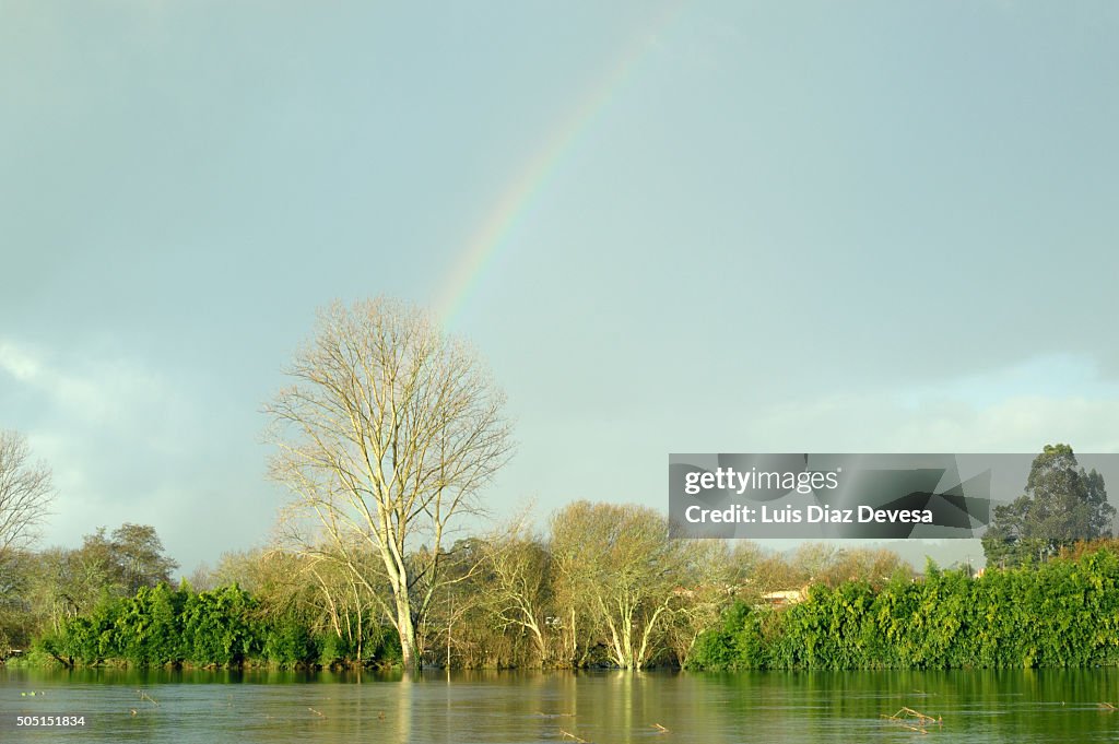 Farmland flooded with rainbow