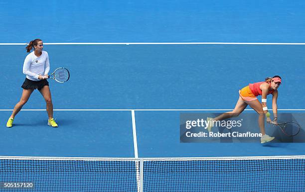 Kimberly Birrell of Australia plays a backhand as Jarmila Wolfe of Australia looks on in the doubles final againsts Xinyun Han of China and Christina...