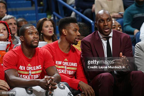 Quincy Pondexter speaks with Norris Cole of the New Orleans Pelicans on the bench during the game against the Charlotte Hornets on January 15, 2016...