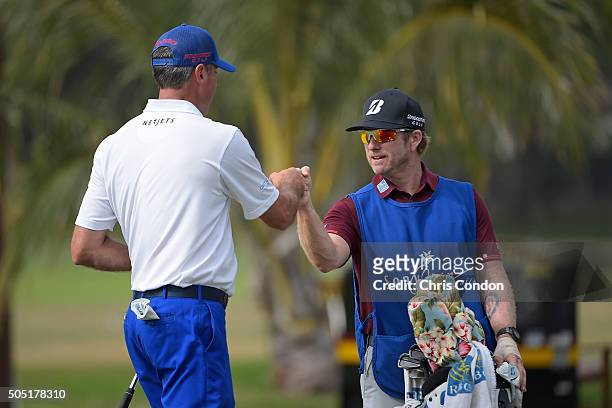 Matt Kuchar makes an eagle on the 9th hole and celebrates with caddie John Wood during the second round of the Sony Open in Hawaii at Waialae Country...