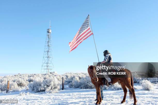 Occupier Duane Ehmer and his horse Hellboy stand at the entrance to the Malheur National Wildlife Refuge Headquarters in Burns, Oregon on January 15,...