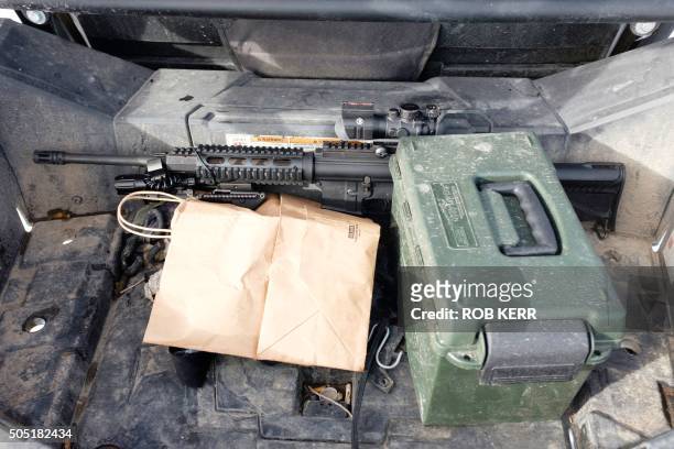 Firearm and ammunition are visible in the back of a vehicle at the Malheur National Wildlife Refuge Headquarters in Burns, Oregon on January 15,...