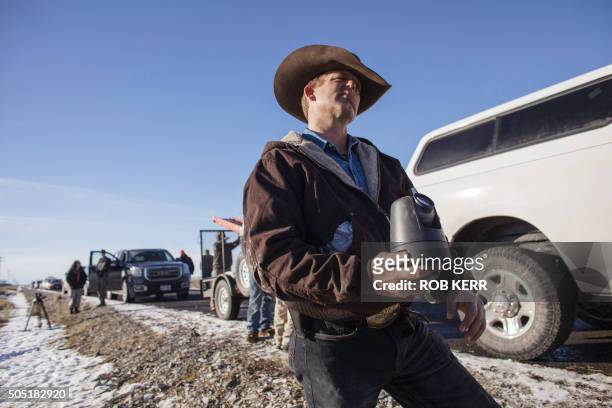 Ryan Bundy shows a Canon lens his group removed from a power pole remote camera location near the occupied Malheur National Wildlife Refuge...