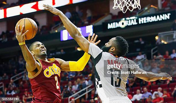 Kyrie Irving of the Cleveland Cavaliers drives with the ball against James Harden of the Houston Rockets during their game at the Toyota Center on...