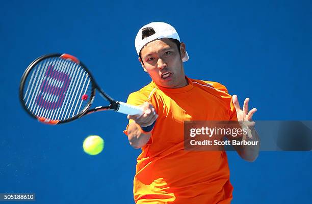 Tatsuma Ito of Japan plays a forehand in his match against Adrian Menendez-Maceiras of Spain during the third round of 2016 Australian Open...