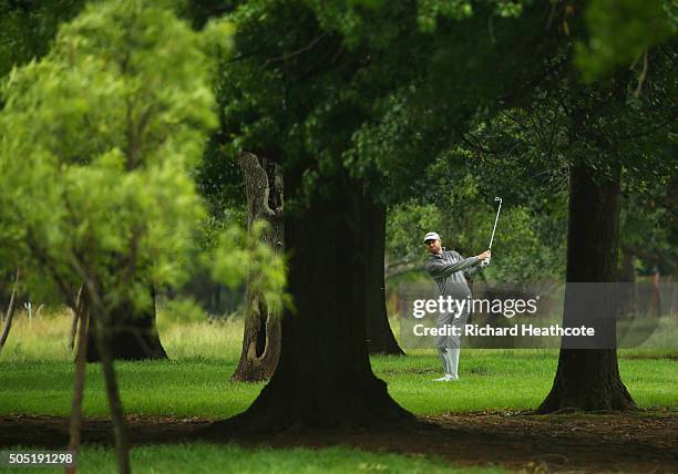 Rhys Davies of Wales plays his second shot through the trees on the 3rd hole on the East Course during day three of the Joburg Open at Royal...