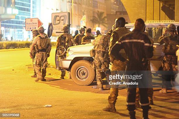 Armored soldiers secure a street outside the Splendid Hotel in Ouagadougou, Burkina Faso, on 15 January 2016. Several people killed and injured in a...