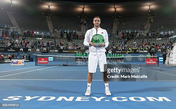 Viktor Troicki of Serbia celebrates and holds aloft the winners trophy after winning the men's final match against Grigor Dimitrov of Bulgaria during...