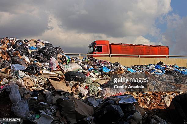 Truck rides past a pile of garbage in Hazimiye neighborhood in Beirut, Lebanon on January 16, 2016. Lebanon agrees to end its garbage problem by...