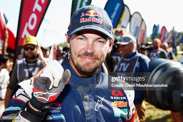 Toby Price of Australia riding on and for KTM 450 RED BULL KTM FACTORY TEAM celebrates winning the overall race as he arrives at the end of stage...