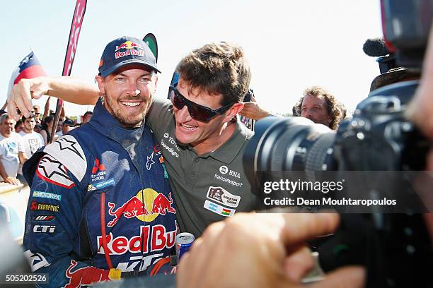 Toby Price of Australia riding on and for KTM 450 RED BULL KTM FACTORY TEAM celebrates winning and is embraced by former Dakar Champion and current...