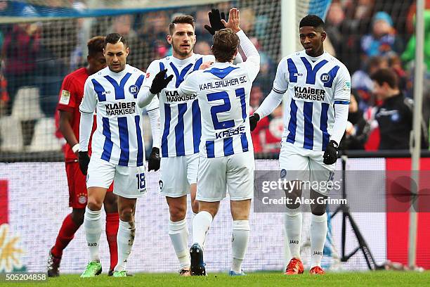 Boubacar Barry of Karlsruhe celebrates his team's first goal with team mates during a friendly match between Karlsruher SC and FC Bayern Muenchen at...