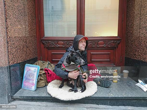 homeless man with his dog. - homeless winter stock pictures, royalty-free photos & images