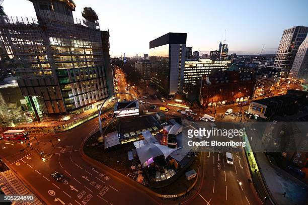 Traffic passes around the Old Street roundabout, also referred to as 'Silicon Roundabout,' in the area known as 'Tech City' at dusk, in London, U.K.,...