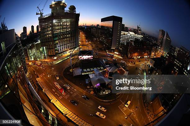 Traffic passes around the Old Street roundabout, also referred to as 'Silicon Roundabout,' in the area known as 'Tech City' at dusk in London, U.K.,...
