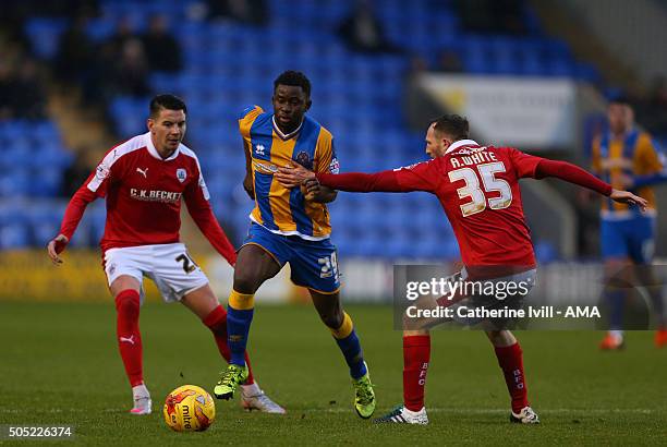 Larnell Cole of Shrewsbury Town gets past Adam Hammill and Aidan White of Barnsley during the Sky Bet League One match between Shrewsbury Town and...