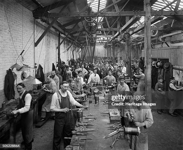 Belgian Munition Works, Clevedon Road, Barnes, Richmond, London, September 1918. Men, women and boys hand finishing munitions. During the First World...