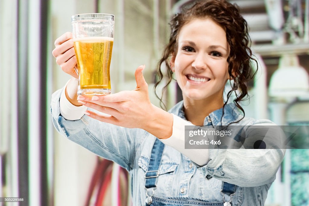 Cheerful female brewmaster at a brewery
