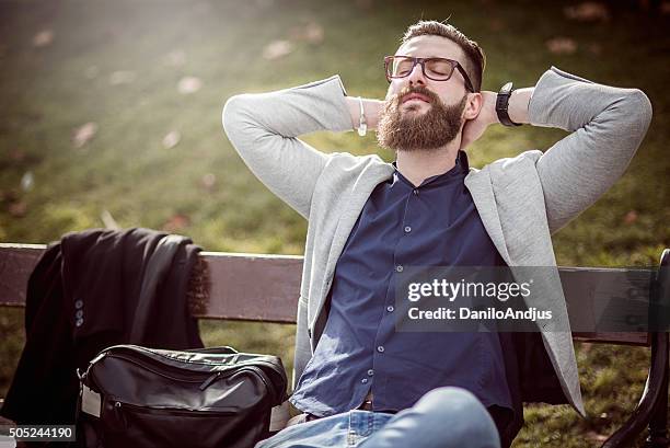 businessman relaxing on the bench after work - businessman meditating stock pictures, royalty-free photos & images